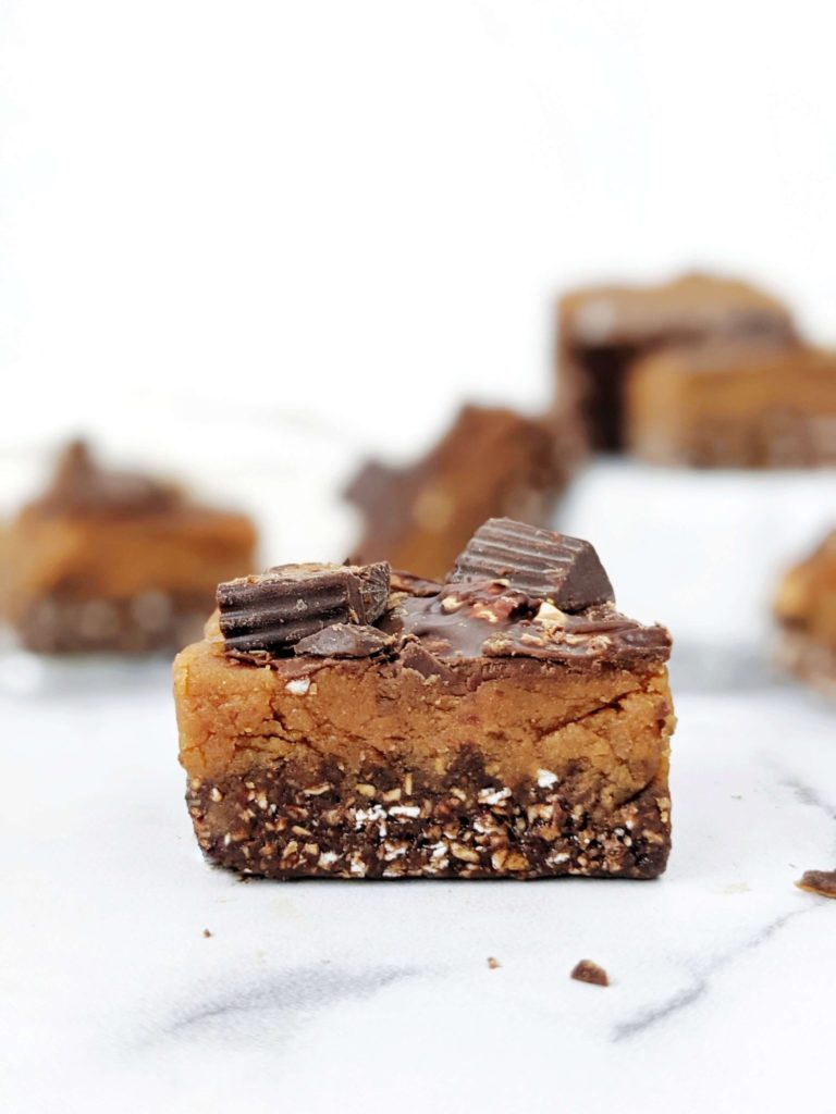 Soft and chewy Peanut Butter Cup Protein Bars with all the chocolate and peanut butter flavor, and topped with chopped PB cups, but gluten free, sugar free and high protein; A much healthier and better option than Reese’s candy!