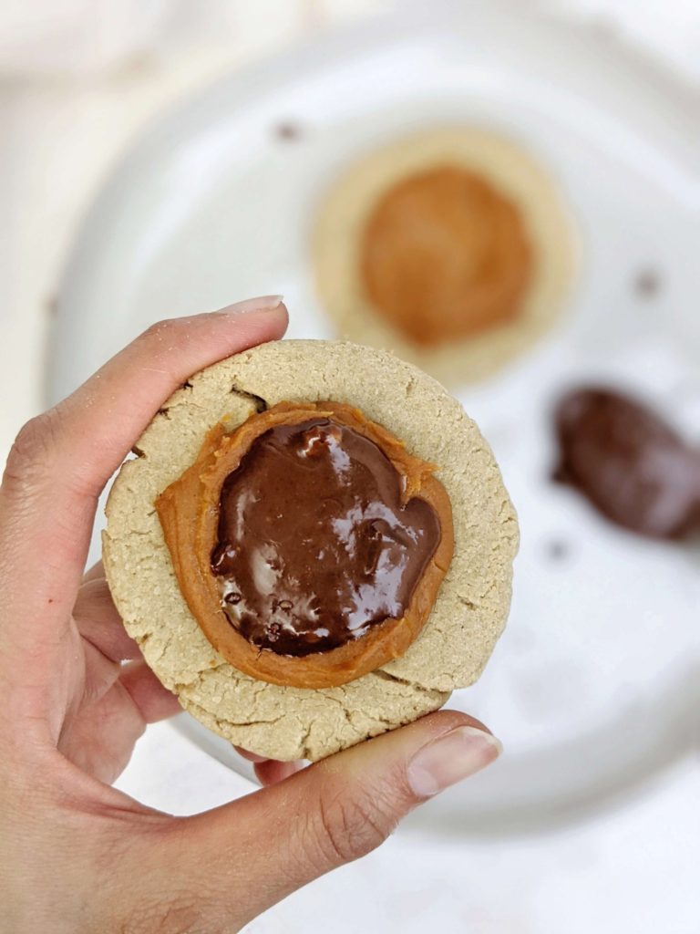 Beautiful Crumbl inspired Twix Protein Cookies made with a vegan and gluten free cookie, peanut butter protein caramel and sugar free chocolate. A copycat Crumbl Twix cookie at home, but healthy and high protein!