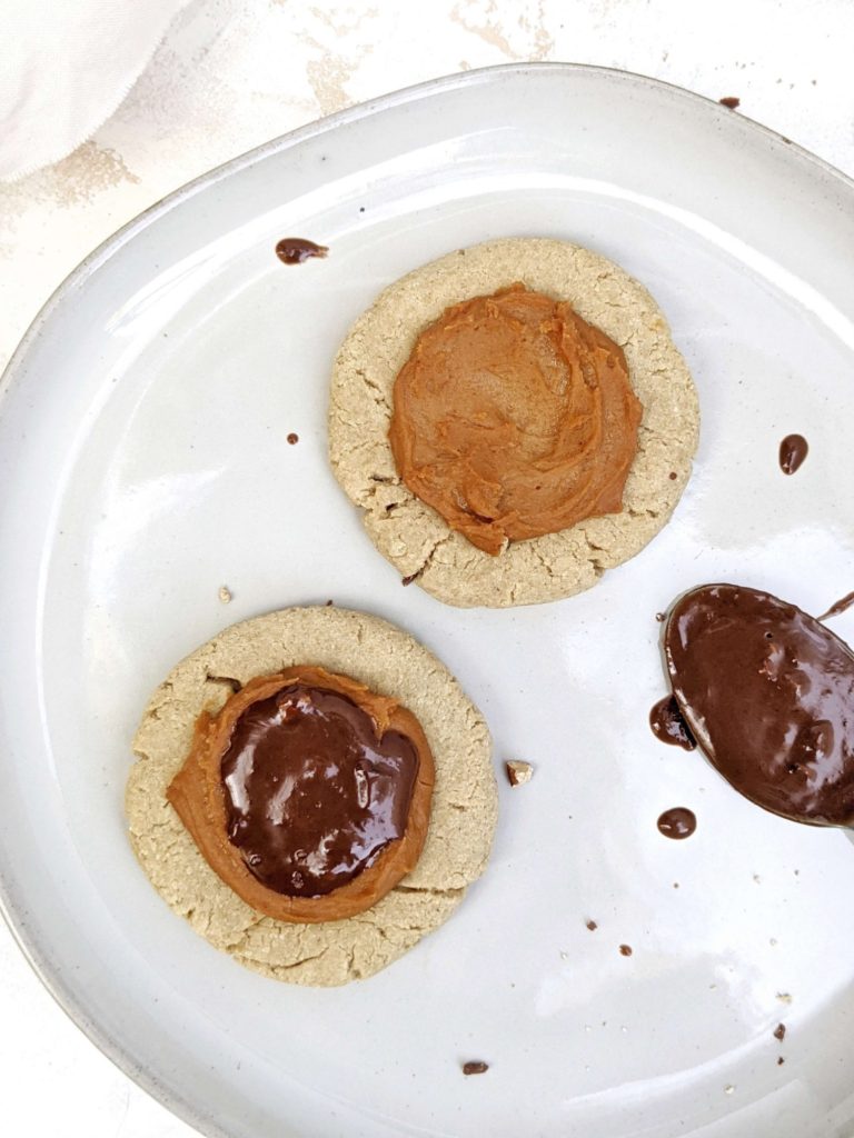 Beautiful Crumbl inspired Twix Protein Cookies made with a vegan and gluten free cookie, peanut butter protein caramel and sugar free chocolate. A copycat Crumbl Twix cookie at home, but healthy and high protein!