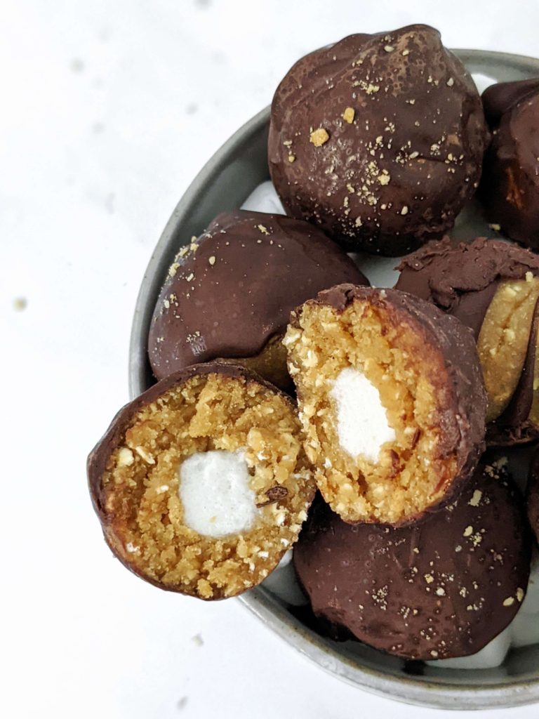 These S’mores Protein Balls are made with graham crackers and marshmallows like a real s'mores desserts, but made healthy with protein powder, collagen and oats! S’mores protein bites are perfect for a snack, dessert or midday energy boost.