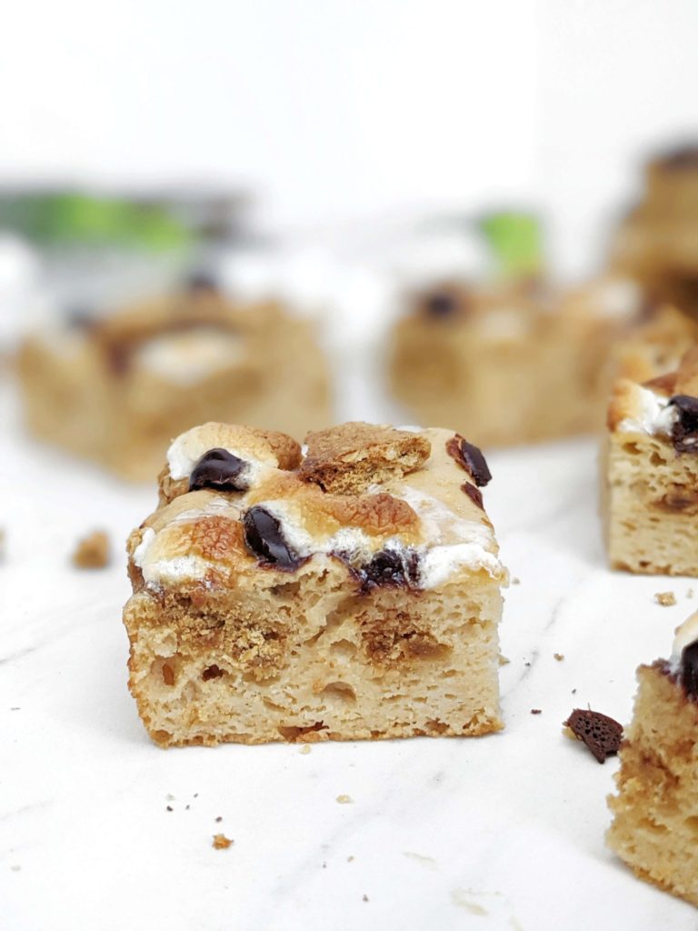 Actually healthy S’mores Protein Blondies made with protein powder and monk fruit instead of sugar, and peanut butter powder instead of oil or butter. These low calorie and low fat protein powder blondies are the perfect healthy S’mores dessert complete with graham crackers, marshmallows and chocolate chips!