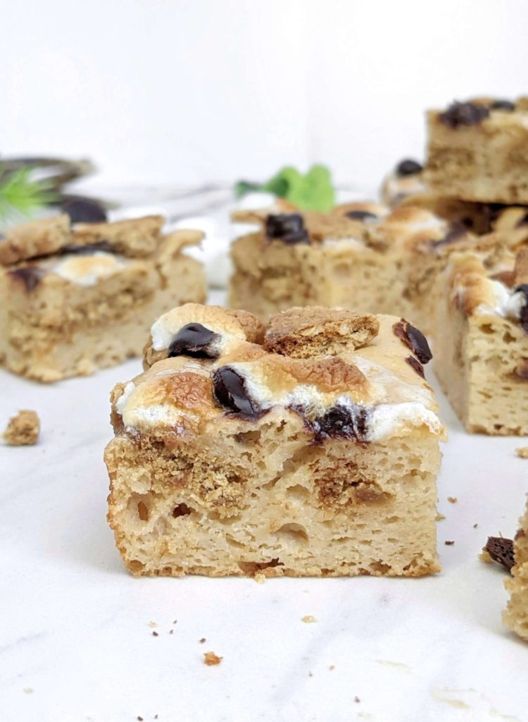 Actually healthy S’mores Protein Blondies made with protein powder and monk fruit instead of sugar, and peanut butter powder instead of oil or butter. These low calorie and low fat protein powder blondies are the perfect healthy S’mores dessert complete with graham crackers, marshmallows and chocolate chips!