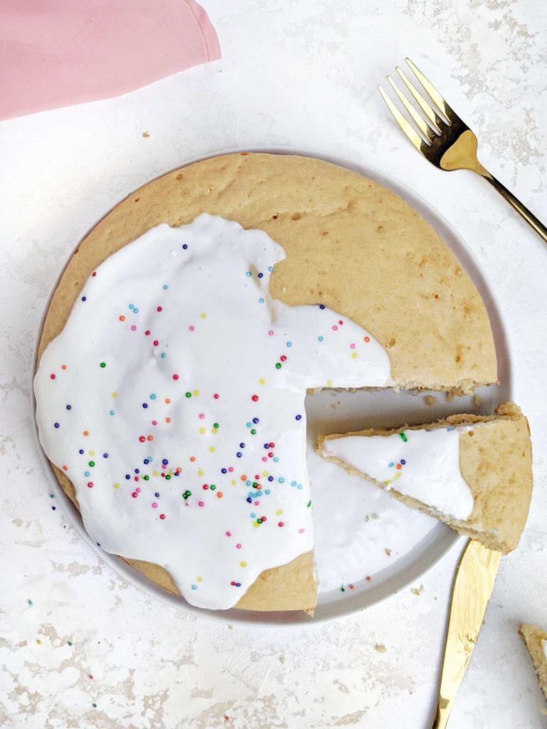 A pretty and pretty perfect Protein Birthday Cake made with whole wheat flour, Greek yogurt and protein powder, and topped with a simple yogurt icing. This Funfetti Protein Cake uses minimal butter, is sugar free and great for a healthy celebration dessert. 