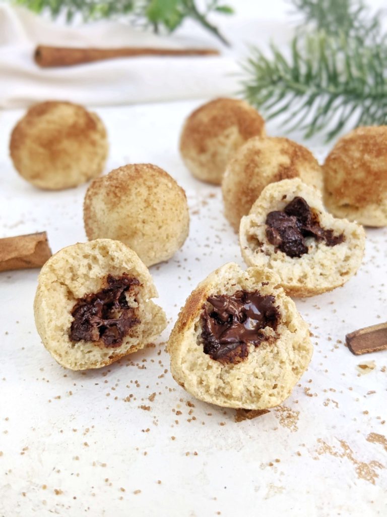 Incredible Chocolate stuffed Protein Churro Bites with just 4 ingredients, and easy! These churro inspired baked protein balls are stuffed with sugar free chocolate and coated with monk fruit cinnamon-sugar for a healthy, high protein dessert.