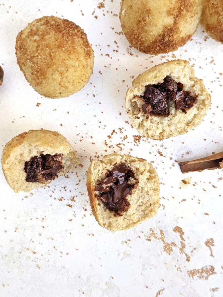 Incredible Chocolate stuffed Protein Churro Bites with just 4 ingredients, and easy! These churro inspired baked protein balls are stuffed with sugar free chocolate and coated with monk fruit cinnamon-sugar for a healthy, high protein dessert.