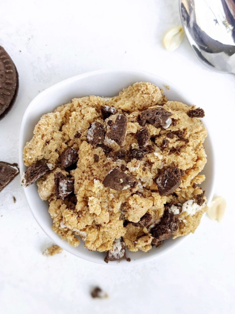 Unbelievably good Peanut Butter Oreo Cookie Dough made with oat flour, protein powder, peanut butter powder and mini Oreo cookies! This no bake healthy cookies and cream cookie dough is gluten free, low fat, low sugar and great for a snack, dessert or post workout treat.