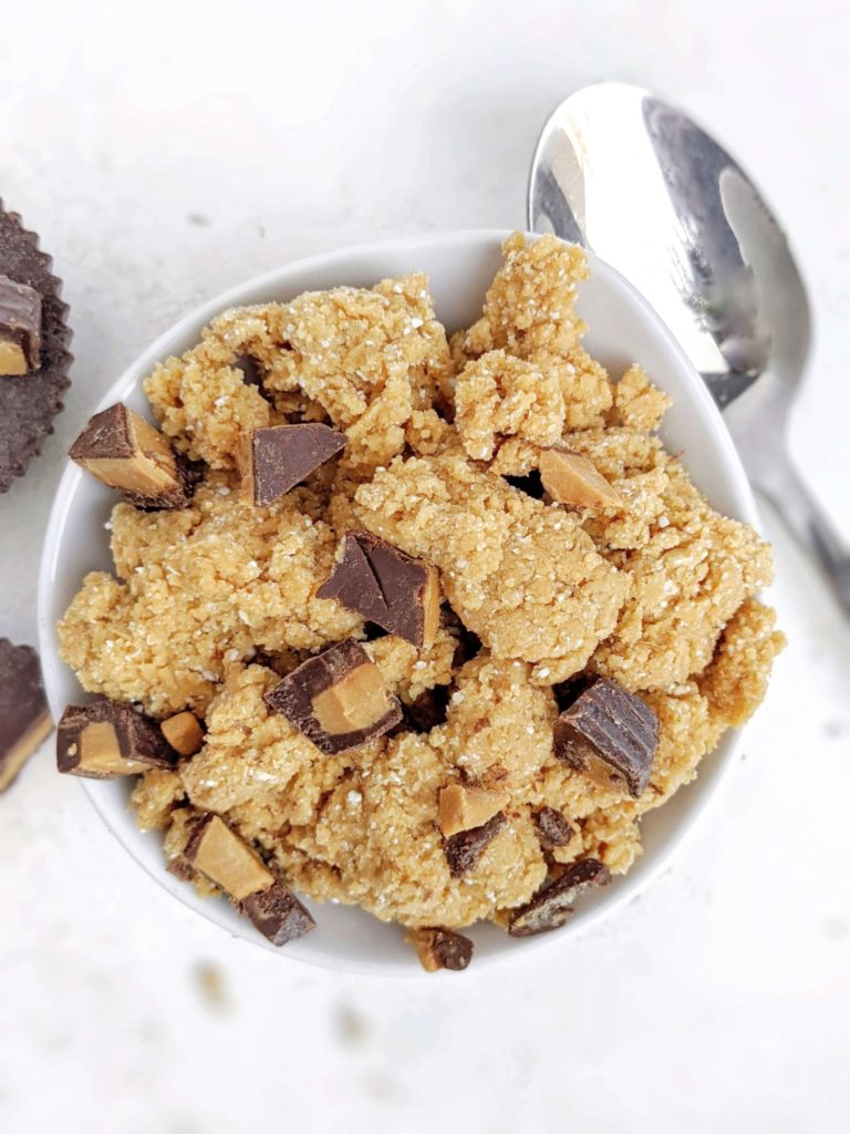 An easy, no bake edible Peanut Butter Cup Protein Cookie Dough with oat flour, protein powder, peanut butter powder and chopped candy! This healthy Reese’s cookie dough is perfect for a single serve snack or dessert. Gluten free, Sugar free, Vegan too!