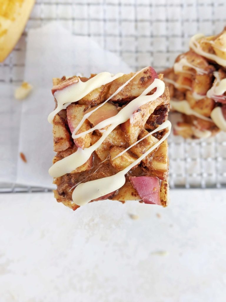 Magical Caramel Apple Protein Bars with 3 layers of protein: pie base, caramel and cinnamon sugar apples! These heathy cinnamon apple protein bars are a great no bake, no sugar energy bar recipe.