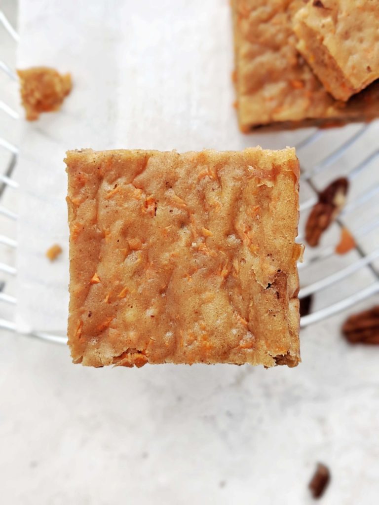 Dense, chewy and light Carrot Cake Protein Blondies with slight crunch of pecans. These healthy carrot cake blondies are made with protein powder, and have no butter; Gluten free, Vegan and sugar free too!