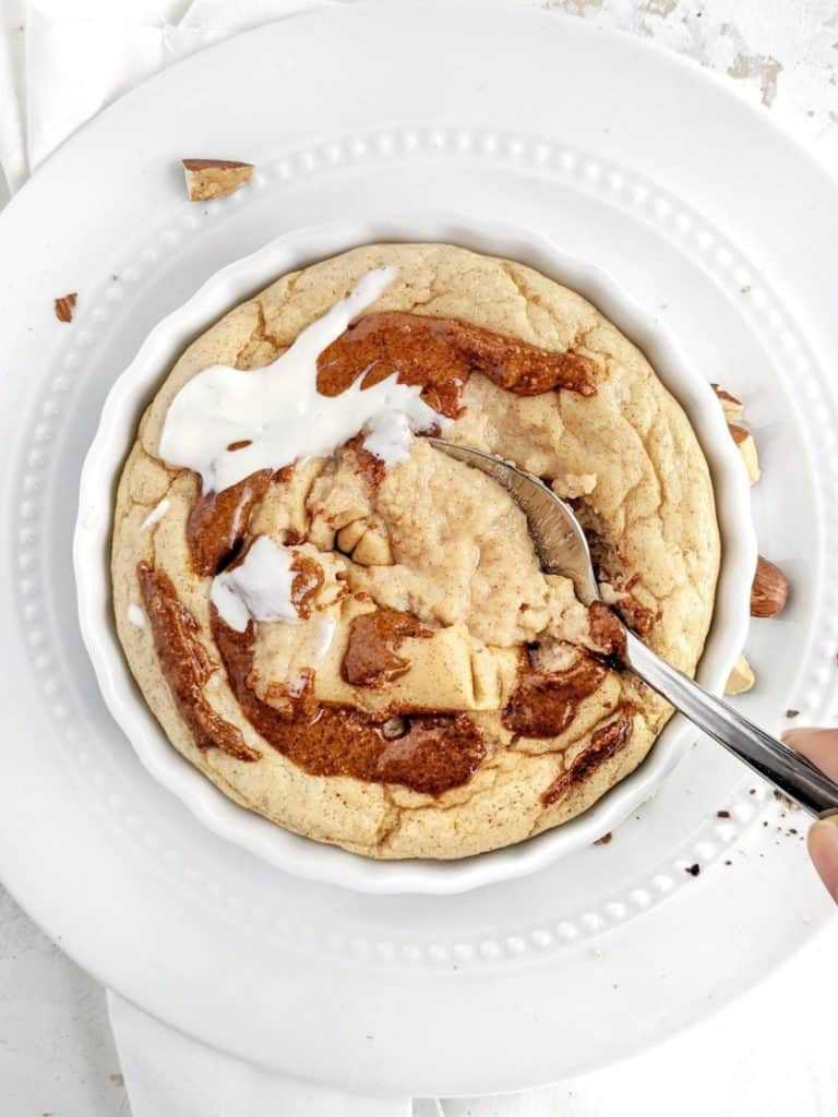 A pretty and pretty Fudgy Cinnamon Protein Mug Cake complete with a swirl and icing. This healthy cinnamon roll protein mug cake uses protein powder, and has no flour or sugar - an easy and keto friendly dessert!