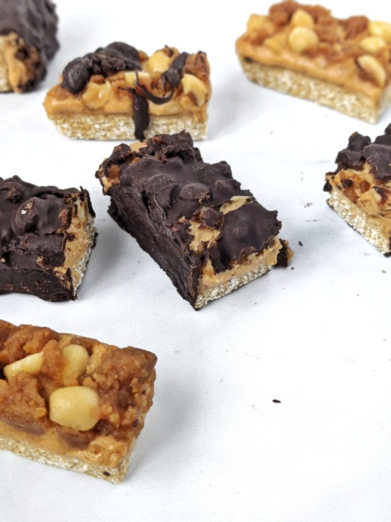 Sweet, chewy and peanutty homemade Snickers Bars that are Vegan, Sugar-free and high in protein too! Made with oat flour, protein powder, peanut butter and stevia-sweetened maple syrup and chocolate, this is the best healthy snickers candy and protein bar out there!