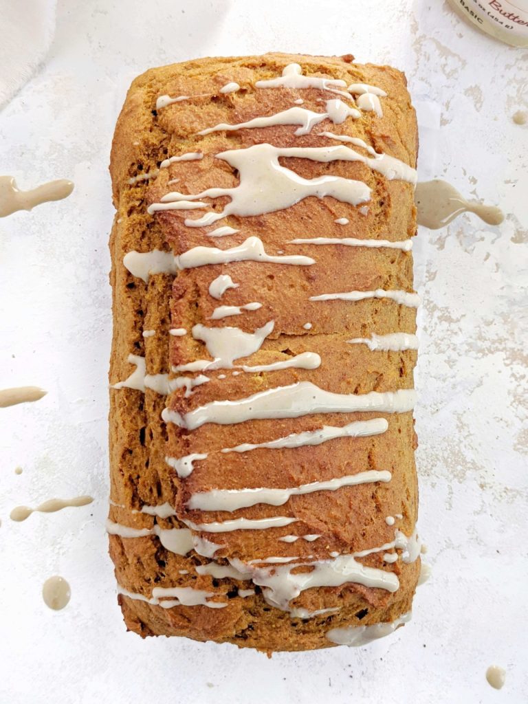 A super cozy Pumpkin Protein Pancake Bread topped with a maple cashew glaze! This healthy pumpkin pancake bread uses protein pancake mix, protein powder, sugar free maple syrup and no oil or butter. A delicious breakfast loaf for fall!