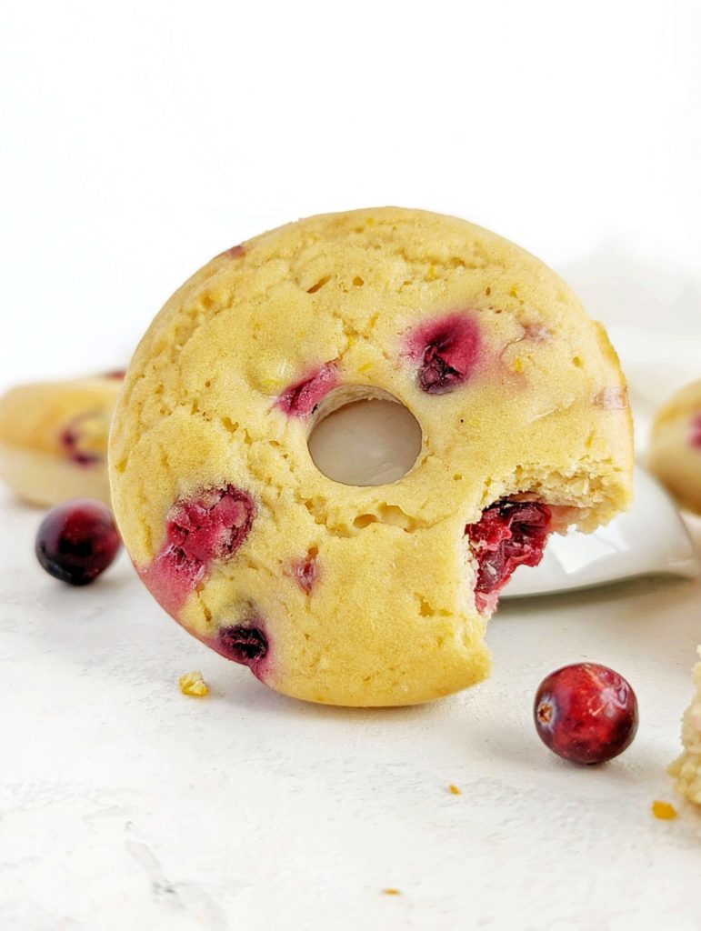 Truly magical Cranberry Orange Protein Donuts loaded with fresh cranberries and the sweet zesty orange. These healthy cranberry donuts use protein powder for sweetness, are sugar free, low calorie and low fat. Just 6 base doughnut ingredients too.