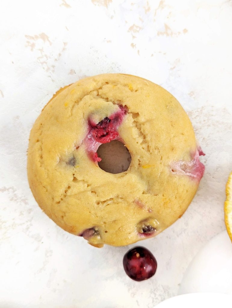 Truly magical Cranberry Orange Protein Donuts loaded with fresh cranberries and the sweet zesty orange. These healthy cranberry donuts use protein powder for sweetness, are sugar free, low calorie and low fat. Just 6 base doughnut ingredients too.