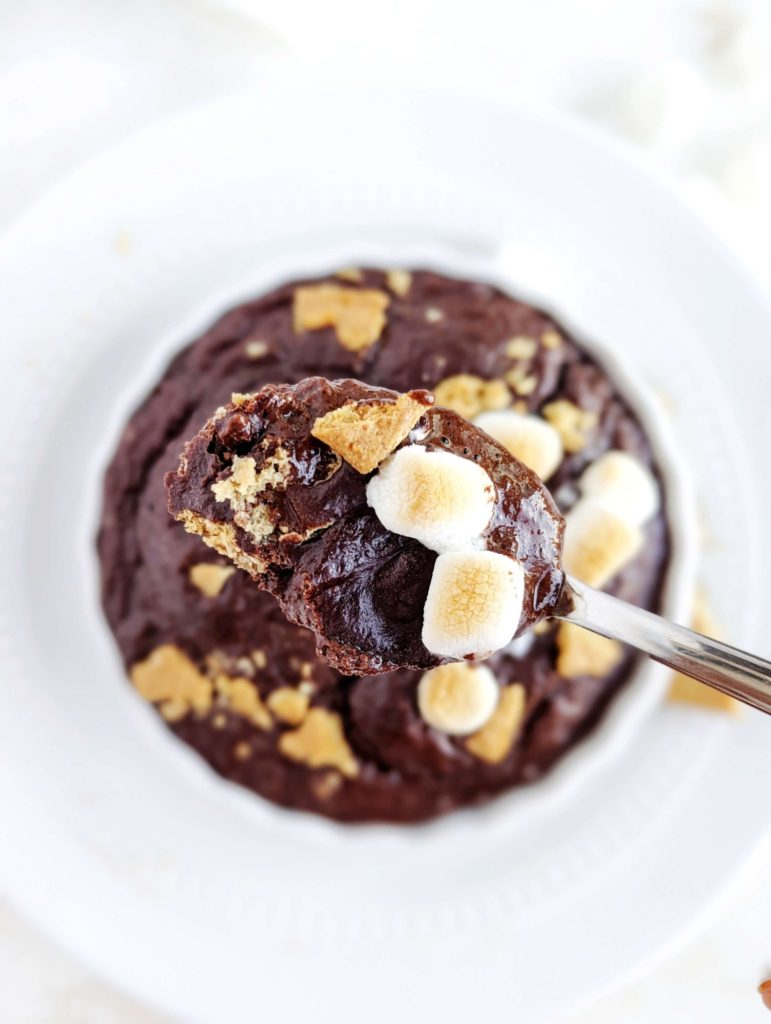 A perfect half baked S’mores Protein Mug Cake made with chocolate protein powder, and complete with grahams and marshmallow! This healthy S’mores mug cake is flourless, sugar free and fat free, but satisfies all the cravings for the summer dessert!