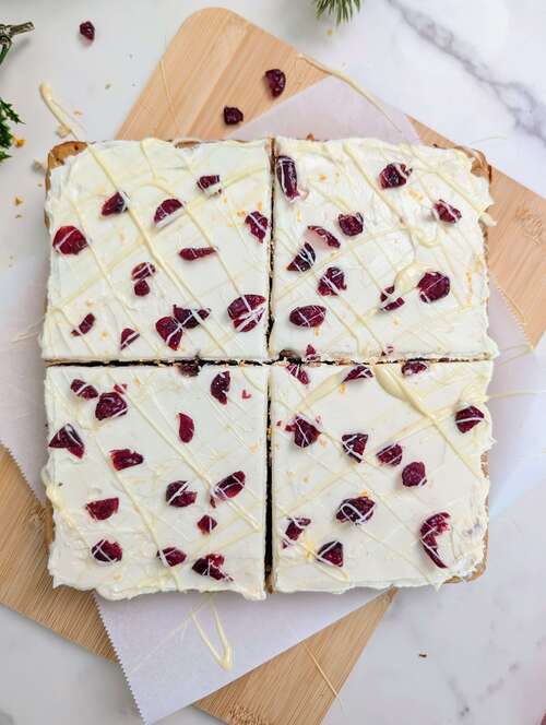 Best Protein Cranberry Bliss Bars recipe that’s heathy, low calorie and has no sugar! The ultimate Starbucks copycat with a cranberry orange blondie and orange zest cream cheese frosting - both with protein powder!