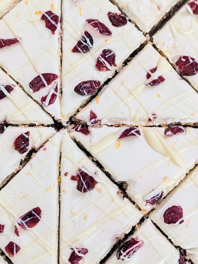 Best Protein Cranberry Bliss Bars recipe that’s heathy, low calorie and has no sugar! The ultimate Starbucks copycat with a cranberry orange blondie and orange zest cream cheese frosting - both with protein powder!