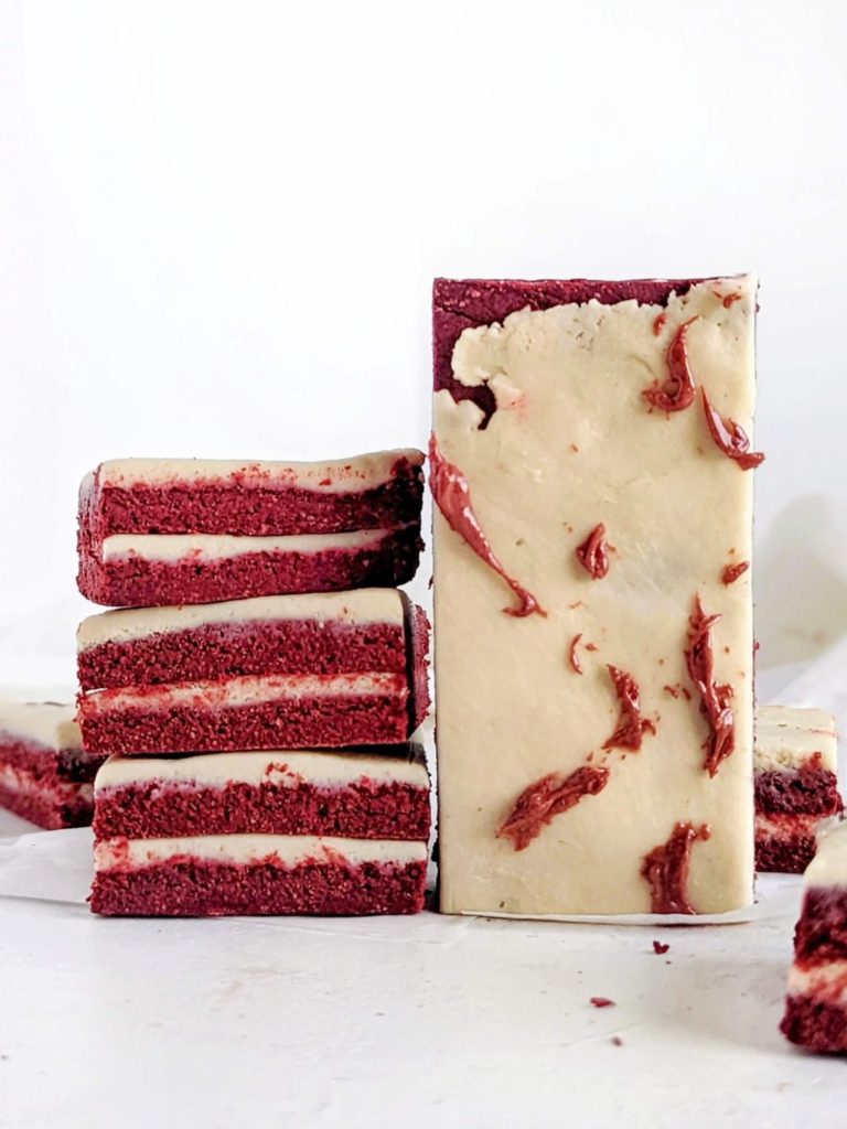 Pretty and perfect Red Velvet Protein Bars complete with layers and a protein cream cheese ‘frosting’! These no bake red velvet bars use protein powder and greek yogurt for a sugar free, low fat and healthy recipe.