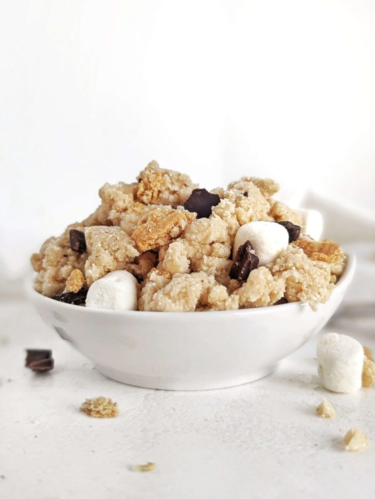 Incredible S’mores Protein Cookie Dough complete with mini marshmallows, chocolate and grahams. This s’mores cookie dough uses oat flour and protein powder, for a healthy, gluten free no bake dessert.