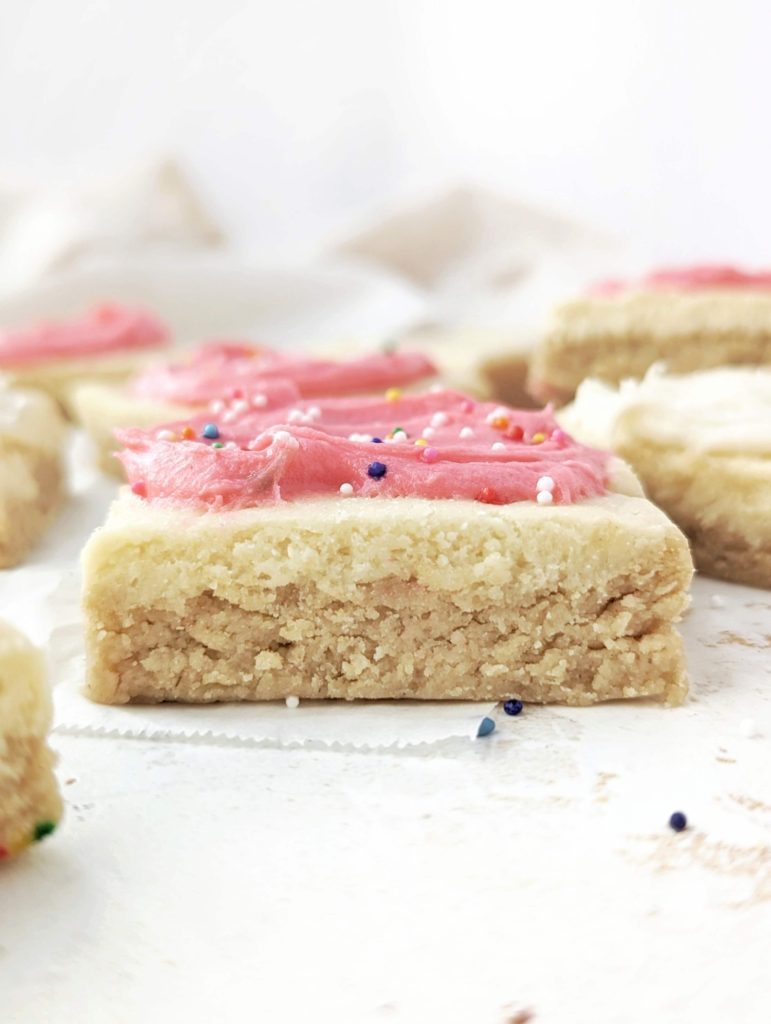 Pretty and perfect frosted Sugar Cookie Protein Bars made with oat flour and protein powder, and actually sugar free! These no bake and heathy sugar cookie protein bars are gluten free and Vegan too.