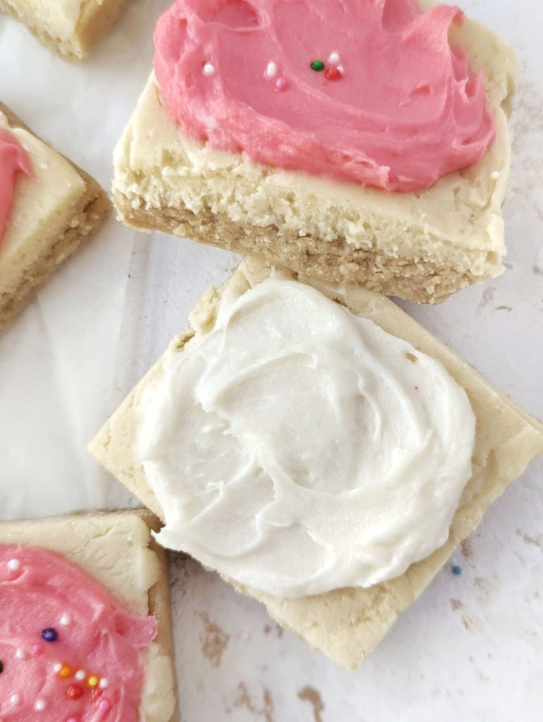 Pretty and perfect frosted Sugar Cookie Protein Bars made with oat flour and protein powder, and actually sugar free! These no bake and heathy sugar cookie protein bars are gluten free and Vegan too.