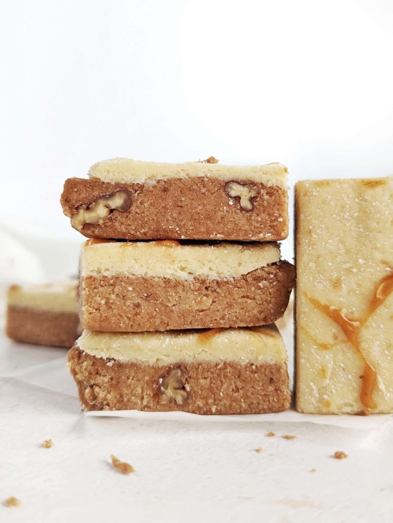 The best no bake Banana Protein Bars with a protein packed banana and frosting layer! These banana bread protein bars are low fat, low carb, gluten free and have no added sugar.