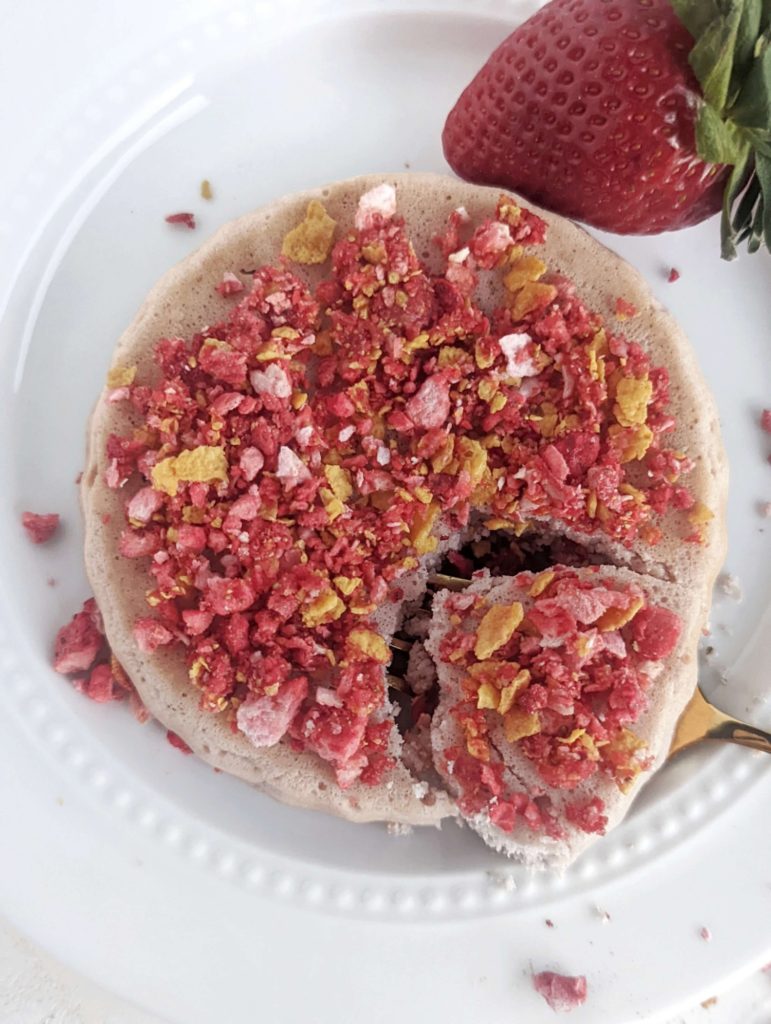 A pretty amazing Protein Strawberry Crunch Cake for a healthy single serving dessert! This strawberry protein mug cake has a no bake strawberry crunch crumble topping and is low carb, gluten free and has no added sugar!