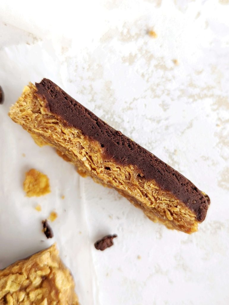 Homemade Butterfinger Protein Bars for your sugar free candy bar cravings with actual nutrition! This healthy Butterfinger recipe is made with corn flakes cereal, protein powder and creamy + powdered peanut butter and has no candy corn!