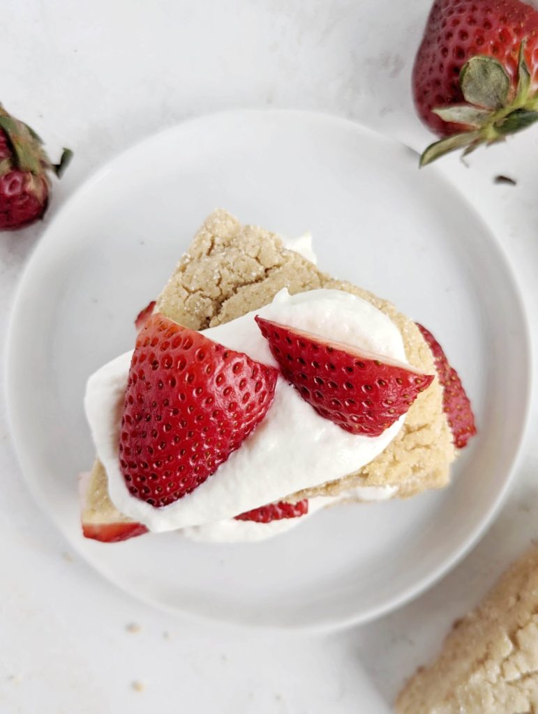 Delicate and super delicious Protein Strawberry Shortcake recipe with a protein scone base and cream layer too. Healthy strawberry shortcake uses protein powder and Greek yogurt and has no sugar, butter, or heavy cream.