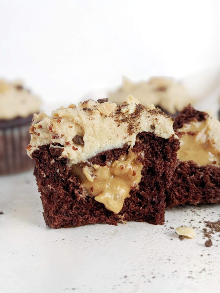 Beautiful Snickers Protein Cupcakes with a soft protein chocolate cupcake, protein caramel filling and protein peanut butter frosting. Healthy filled Snickers cupcakes are sugar free, low fat, and easily Vegan too!