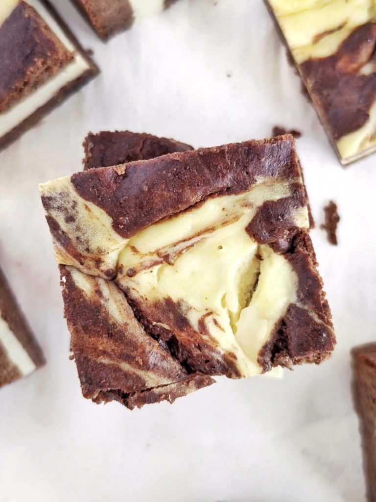 Super good Protein Cheesecake Brownies with swirls of brownie and cheesecake! These healthy cream cheese brownies are made with protein powder, monk fruit and Greek yogurt for a sugar free and butter-free dessert!