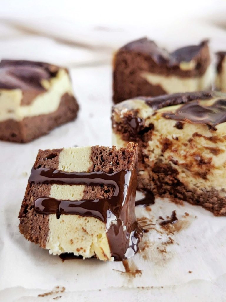 Super good Protein Cheesecake Brownies with swirls of brownie and cheesecake! These healthy cream cheese brownies are made with protein powder, monk fruit and Greek yogurt for a sugar free and butter-free dessert!