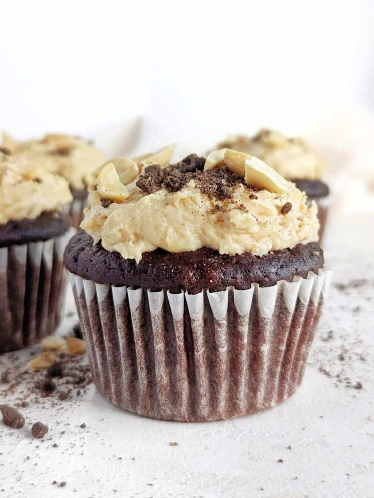 Beautiful Snickers Protein Cupcakes with a soft protein chocolate cupcake, protein caramel filling and protein peanut butter frosting. Healthy filled Snickers cupcakes are sugar free, low fat, and easily Vegan too!