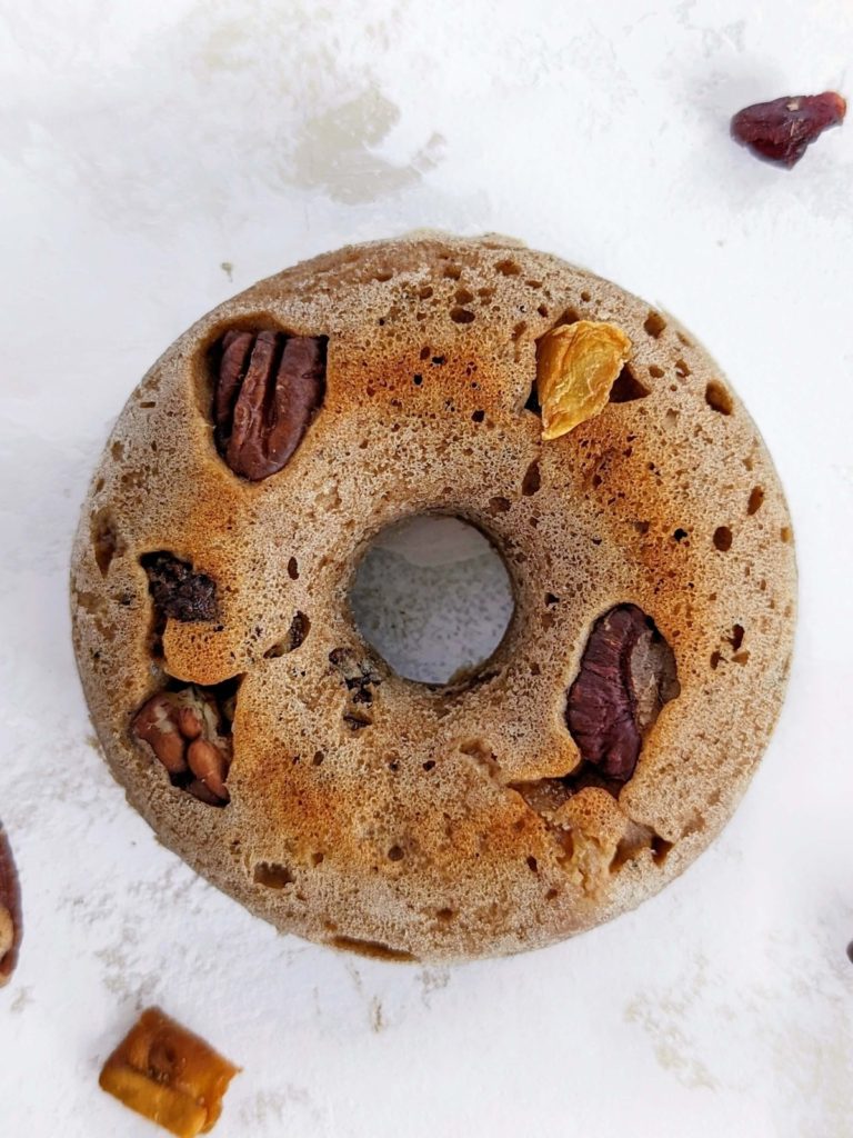 Super easy and high protein Fruitcake Donuts with no sugar added are perfect for Christmas! Healthy fruit cake donuts use protein powder for sweetness, but have all the spiced flavor and dried fruits you’d expect in this treat.