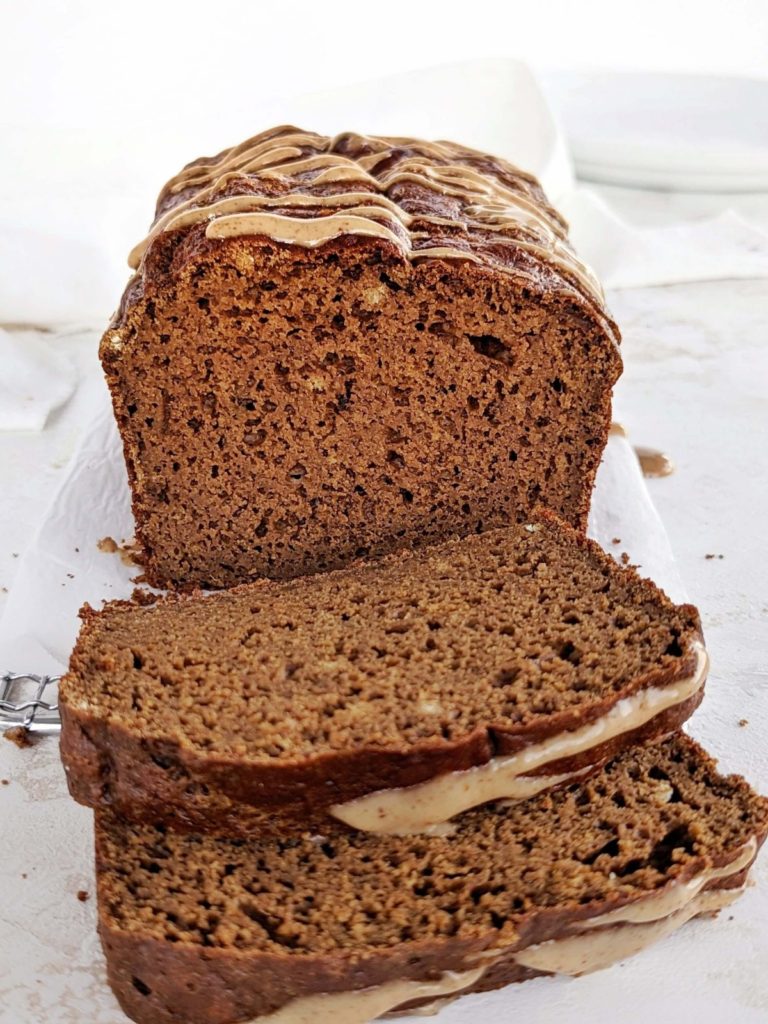 Healthy and low calorie Protein Gingerbread Loaf with a gingerbread almond glaze for extra Christmas flavor! High protein molasses bread has no oil, butter or sugar, but uses applesauce, protein powder and just the right amount of molasses.