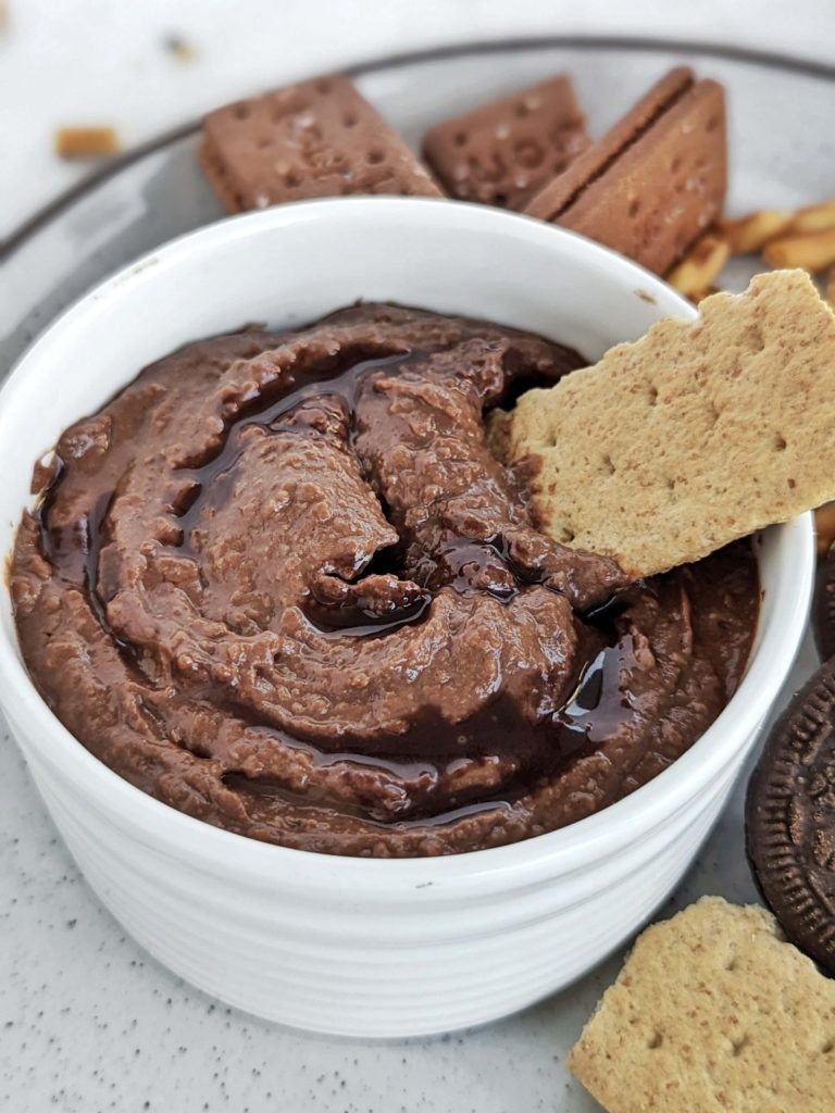 The best Chocolate Protein Hummus recipe made with chickpeas, protein powder and applesauce. Healthy chocolate chickpea dip is a great protein-packed snack for your next chip-and-dip party.
