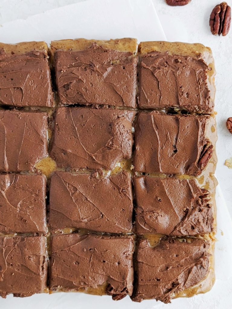 Ooey-gooey Turtle Protein Bars with layers of a caramel-y base, caramel, pecans and chocolate frosting, but all high protein and low sugar! Healthy chocolate caramel pecan turtle bars to satisfy those cravings.