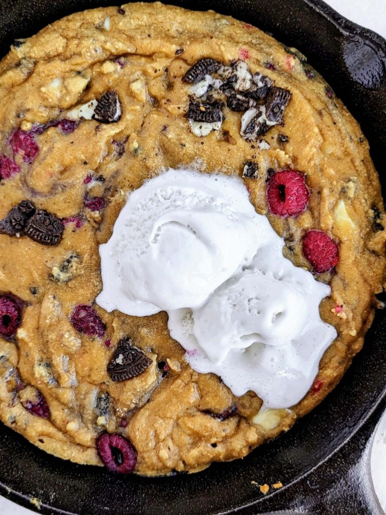 Ultimate Oreo Raspberry Protein Skillet Cookie perfect for Valentine’s Day! Healthy raspberry skillet cookie recipe is low fat, low sugar and great with a scoop of ice cream.