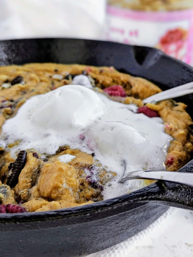 Ultimate Oreo Raspberry Protein Skillet Cookie perfect for Valentine’s Day! Healthy raspberry skillet cookie recipe is low fat, low sugar and great with a scoop of ice cream.
