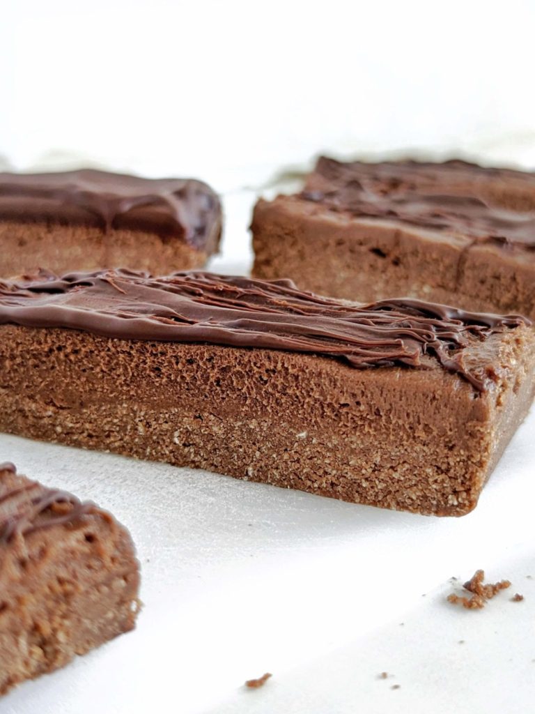 Chocolate Mousse Protein Bars are a healthy and delicious snack to indulge with no guilt. Easy, no bake recipe with a high protein chocolate base, mousse and chocolate topping.