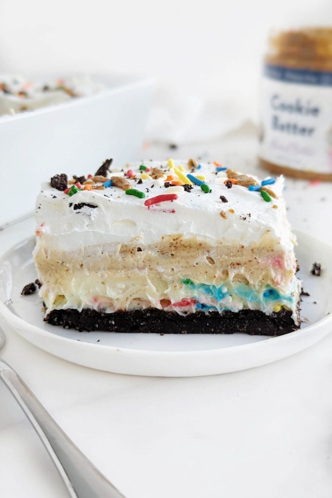 Oreo Birthday Cake Dessert Lasagna is the high protein dessert of your dreams! Oreo base, birthday cake protein pudding, Oreo birthday cake protein pudding and whipped topping too - all healthy and low sugar.