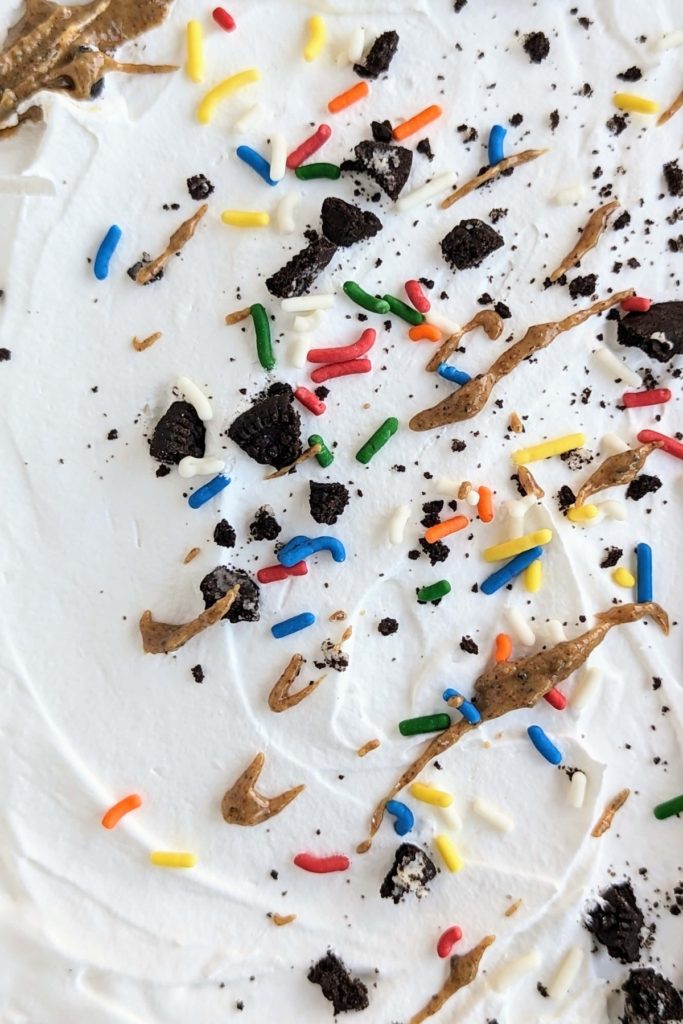 Oreo Birthday Cake Dessert Lasagna is the high protein dessert of your dreams! Oreo base, birthday cake protein pudding, Oreo birthday cake protein pudding and whipped topping too - all healthy and low sugar.