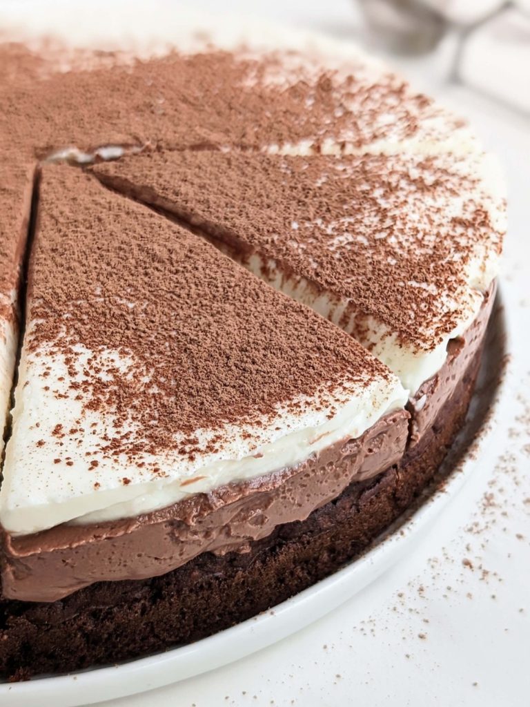 Healthy Chocolate Mousse Cake is high protein, low fat and low sugar too! Triple Chocolate Mousse Cake with a high protein chocolate cake, protein chocolate mousse, white chocolate mousse and cocoa powder.