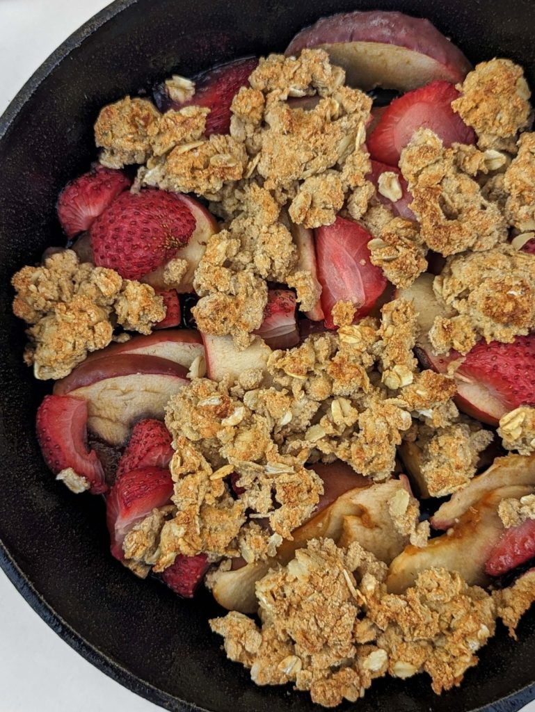 Healthy Strawberry Apple Crisp that's as delicious as it is nutritious! A sweet, but added sugar free blend of apples and strawberries with a high protein, low fat, sugar free and gluten free oat crumble.