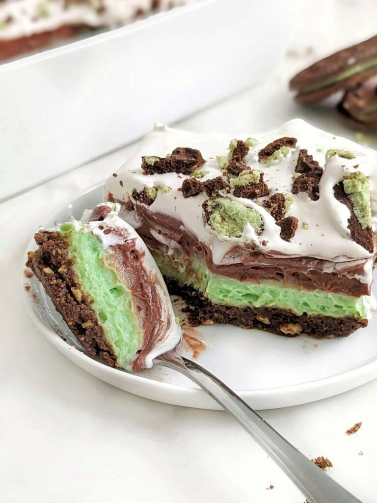 Easy and Healthy Mint Chocolate Dessert with layers of a sugar-free mint chocolate oreo base, mint protein pudding, chocolate protein pudding and low fat cool whip!