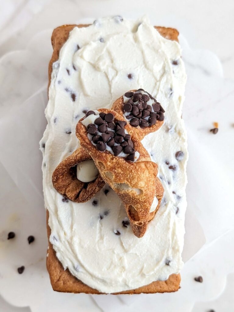 Legit the most amazing Healthy Cannoli Cake - a high protein, sugar free and low fat sponge cake with protein ricotta frosting and sugar free mini chocolate chips.