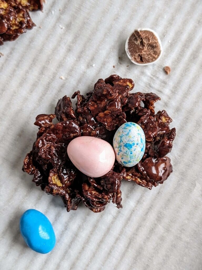 Make the best ever Protein Easter Egg Nests with chocolate protein powder and cornflakes for an easy, no bake snack! Healthy Mini Egg Nests are low fat, low sugar and low calorie.