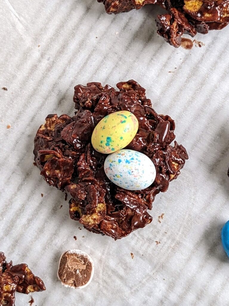Make the best ever Protein Easter Egg Nests with chocolate protein powder and cornflakes for an easy, no bake snack! Healthy Mini Egg Nests are low fat, low sugar and low calorie.