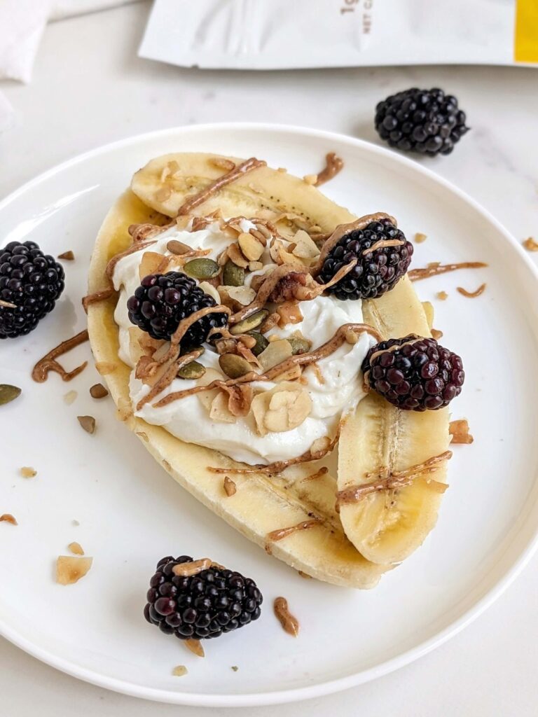 Most easy High Protein Banana Split that’s perfect for a post workout snack or dessert! Healthy banana split has a protein powder yogurt mix, sugar free granola, berries and a protein almond butter too!