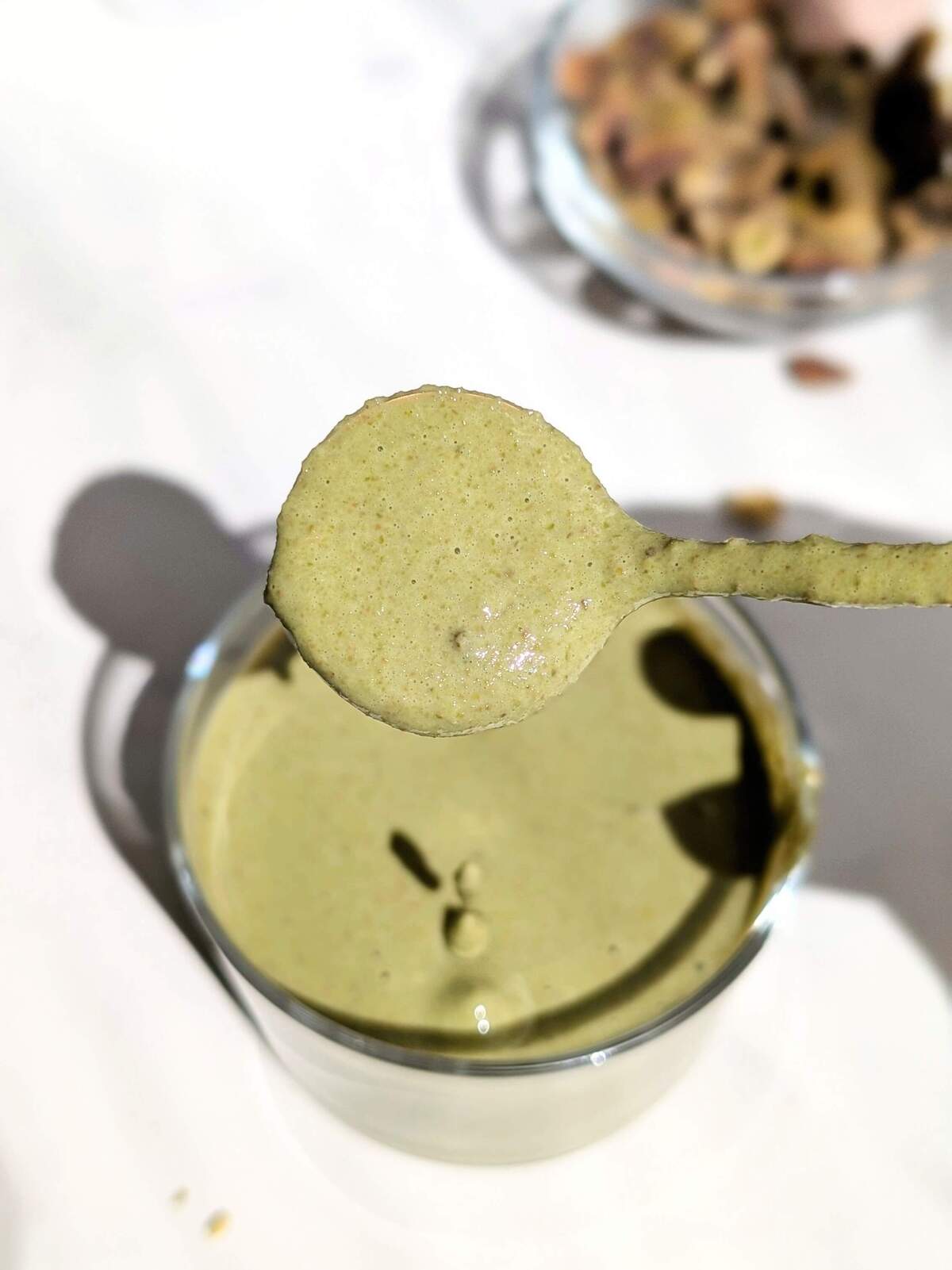 The best Healthy Pistachio Cream recipe out there with no sugar or white chocolate or oil! This high protein pistachio cream uses protein powder and almond milk for a low fat, low calorie, sugar free and keto pistachio dessert spread!